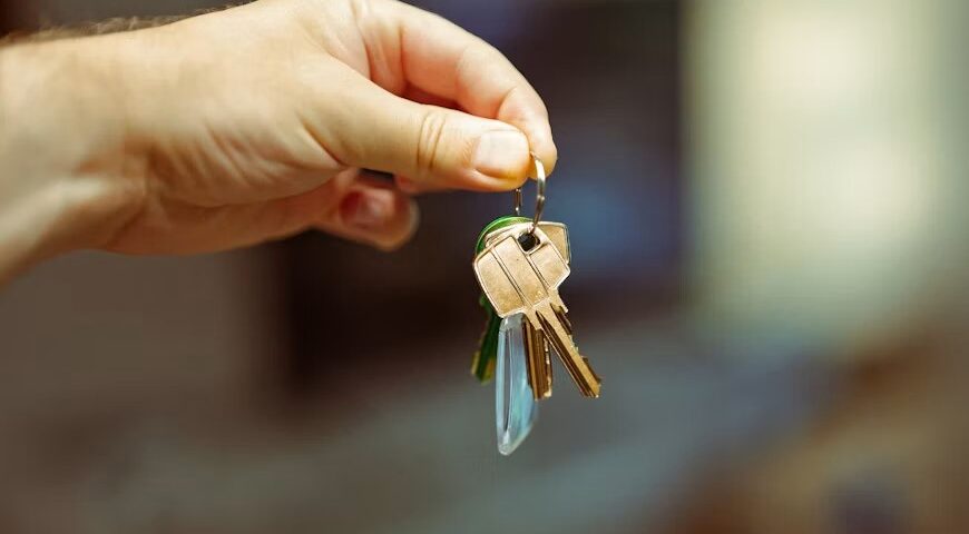 A hand holding keys to a home